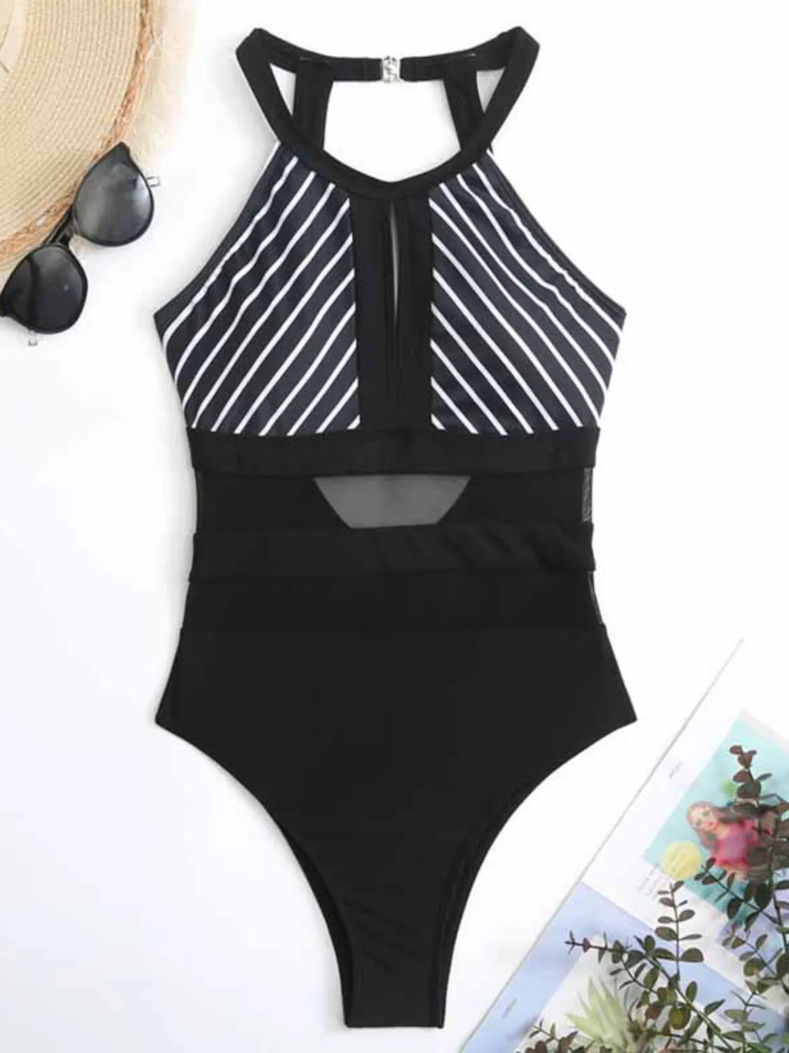 Black swimsuit with fine white diagonal stripes laid flat, front view with sheer waist panels