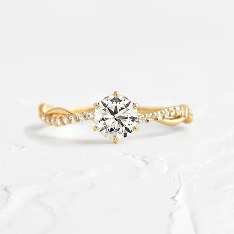 Profile view of the gold-tone zircon ring on a hand