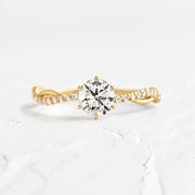 Profile view of the gold-tone zircon ring on a hand
