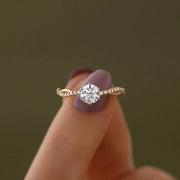 Round clear zircon solitaire ring viewed from the front on white