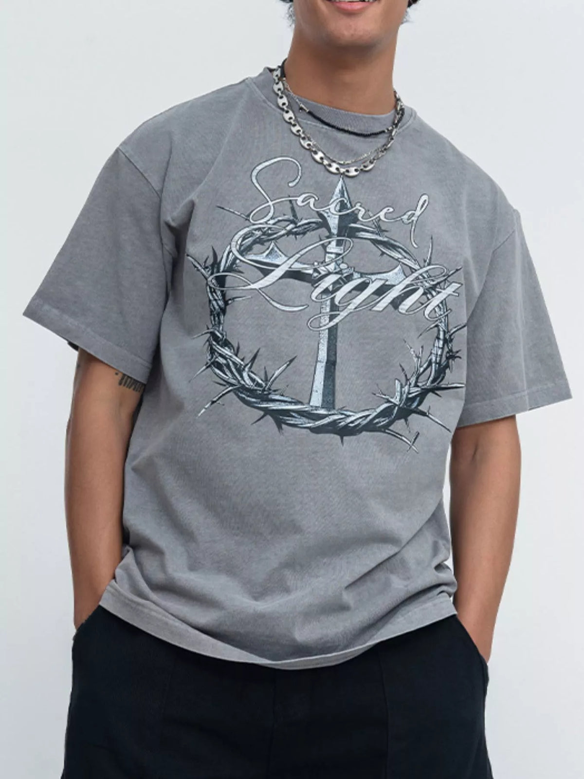 Model wearing gray washed tee with ornate circular graphic