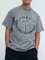Model wearing gray washed tee with ornate circular graphic