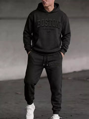 Model wearing black Boston hoodie and matching joggers