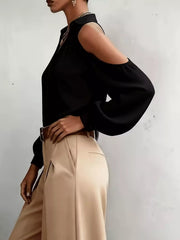 Side view of black cold-shoulder blouse with long sleeve cutout.