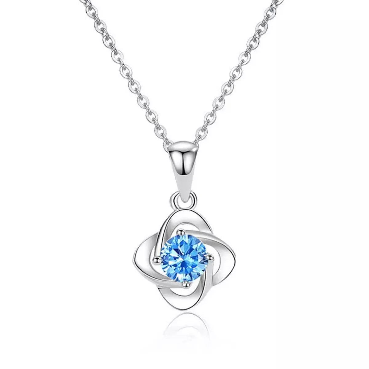 Four-leaf clover pendant on a silver-tone chain against white background