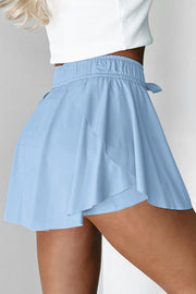 Side view of light blue skort showing the layered flared overlay.