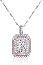 Front view of a rounded rectangular pendant necklace with pink and clear stone borders