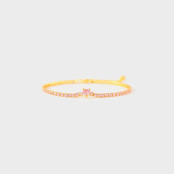 Close view of the heart-shaped zircon accent on a gold bracelet