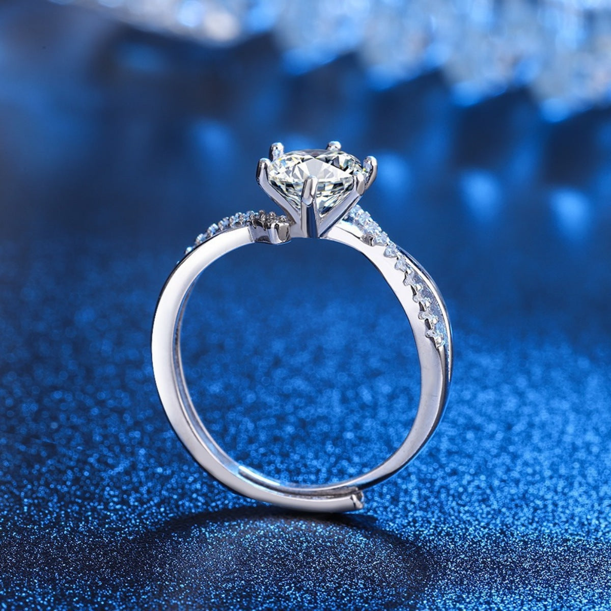 Side view of round moissanite ring showing raised setting and pavé band