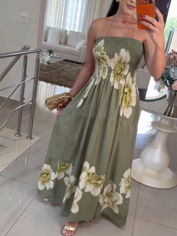 Front view of olive green strapless maxi dress with smocked bodice and large white floral print.