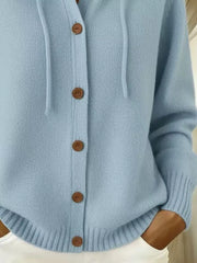 Detail of light blue cardigan ribbed hem and button-front closure