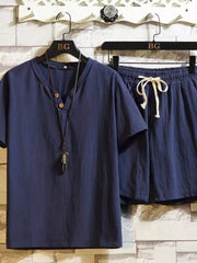 Navy short-sleeve button-front shirt and matching drawstring shorts on hangers