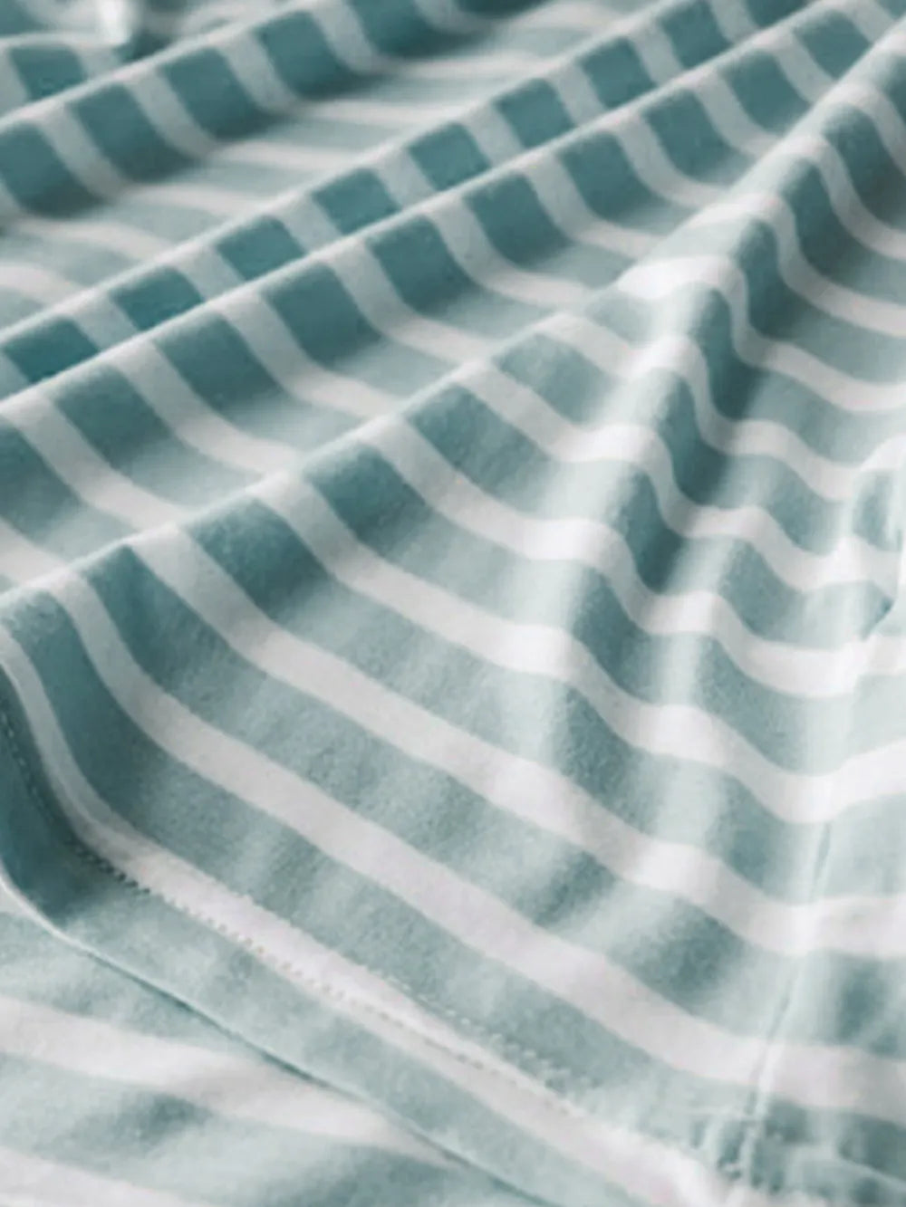 Sage green and white striped shirt fabric close-up