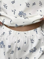 Close front view of dark botanical print top and shorts showing gathered waistband