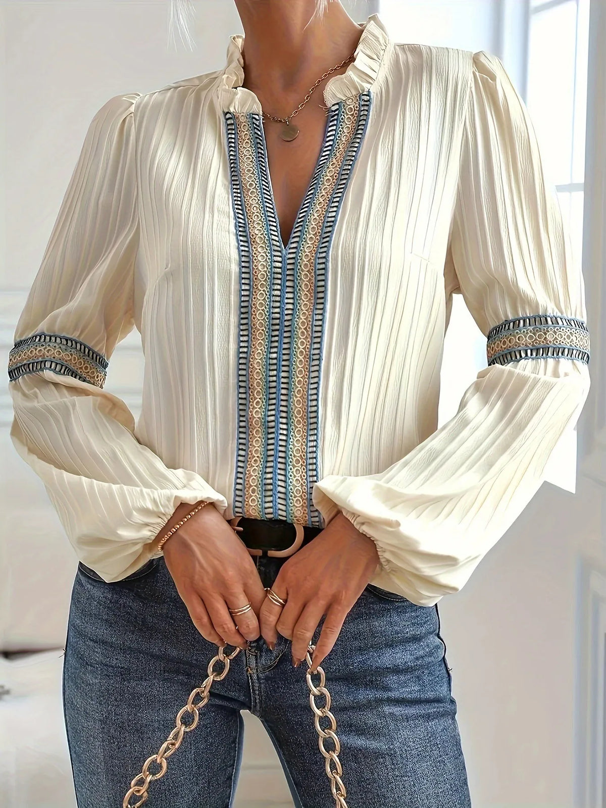 Notched textured balloon-sleeve blouse in cream striped front view