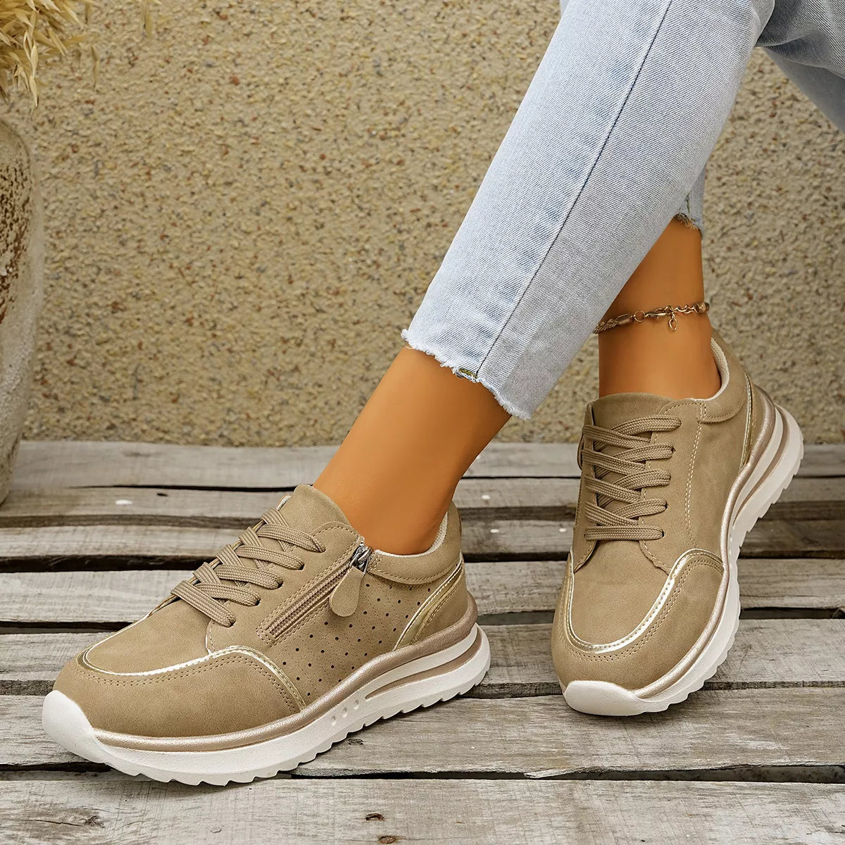 Pair of taupe lace-up sneakers, side view