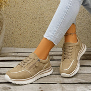 Pair of taupe lace-up sneakers, side view