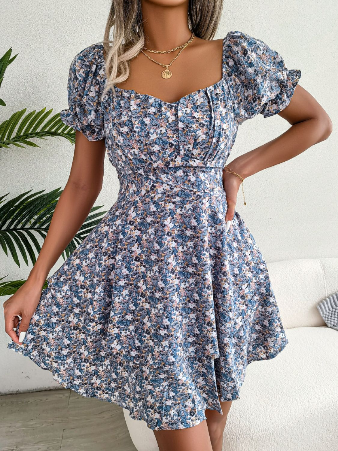 Front view of blue floral mini dress with puffed flounce sleeves