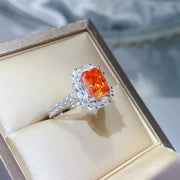 Angled view of orange center stone ring in a presentation box