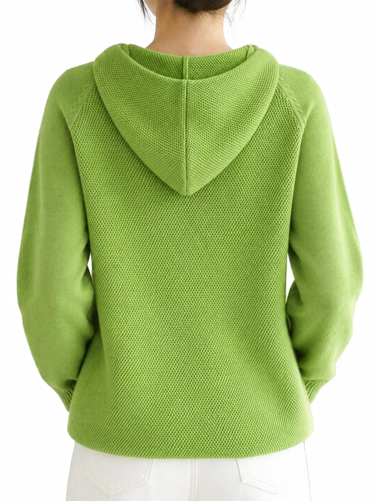 Back view of the light green knit sweater showing the hood's centre seam.