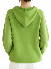 Back view of the light green knit sweater showing the hood's centre seam.