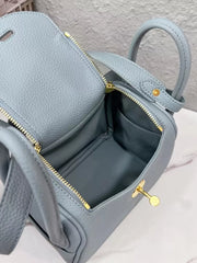 Open blue crossbody bag showing its interior compartment