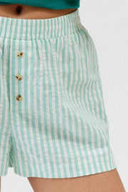 Close-up of mint green stripe fabric and shorts hem