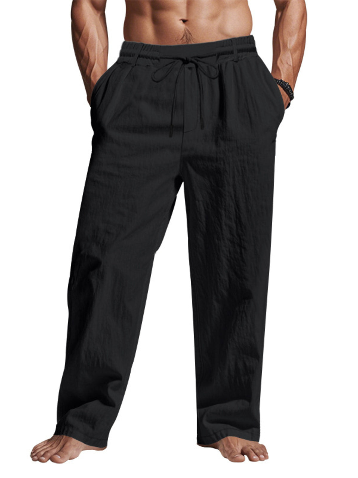 Model wearing black loose-fit drawstring pants, front view
