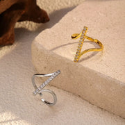 Gold-tone and silver-tone irregular open rings with crossed rhinestone bars on stone blocks