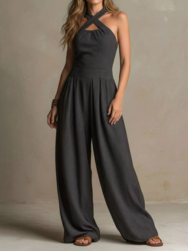 Charcoal wide-leg jumpsuit with crossed halter straps and a small chest cutout, front view.