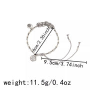 Silver-tone charm bracelet on white with length and weight measurements marked beside it.