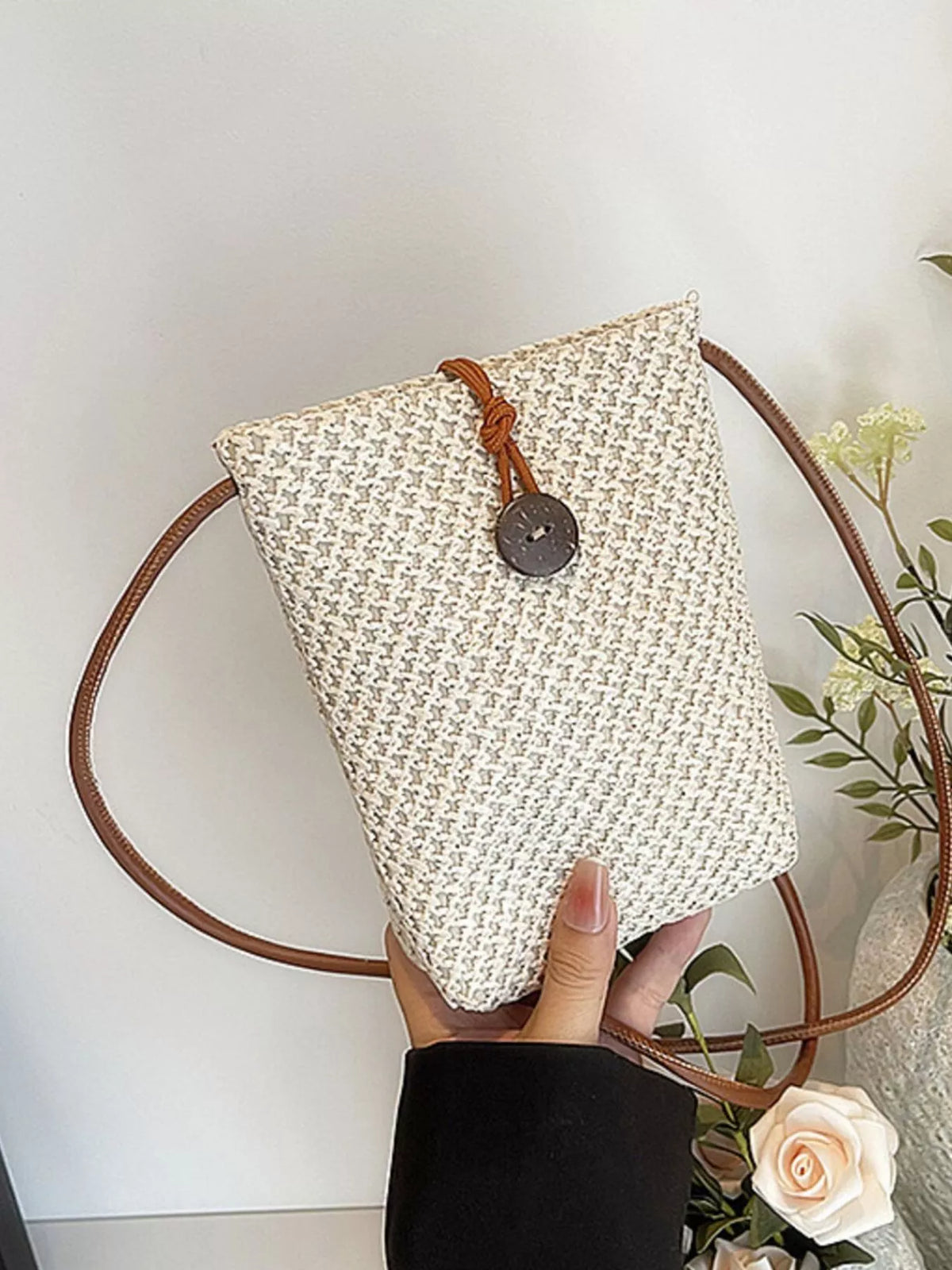 Off-white woven-texture mini crossbody bag with brown strap and button-loop closure