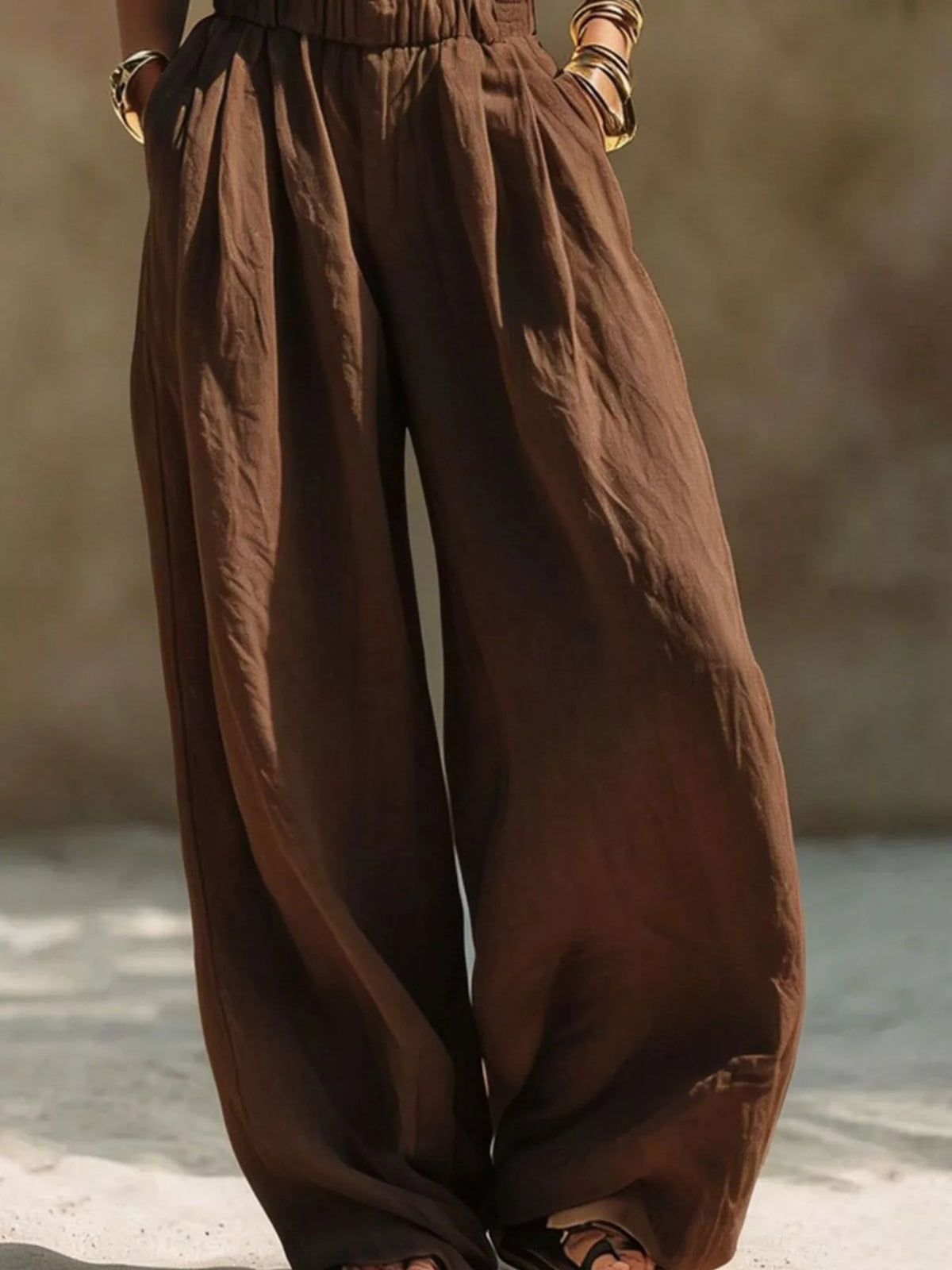 Front detail of brown wide-leg pants with gathered waist and side pockets