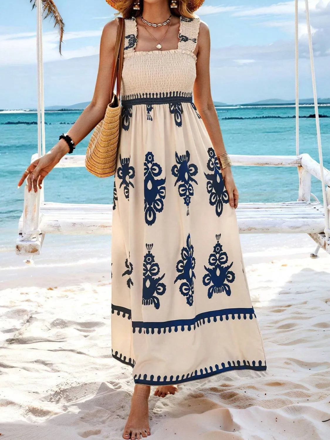 Model wearing cream maxi dress with blue floral pattern