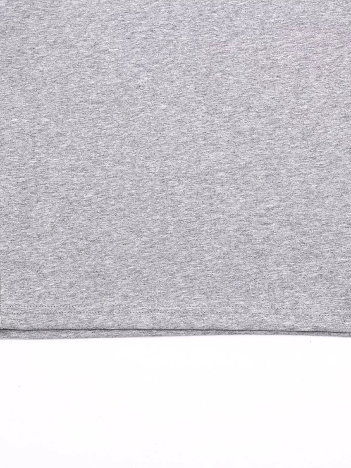 Close-up of gray crewneck T-shirt fabric and finished edge