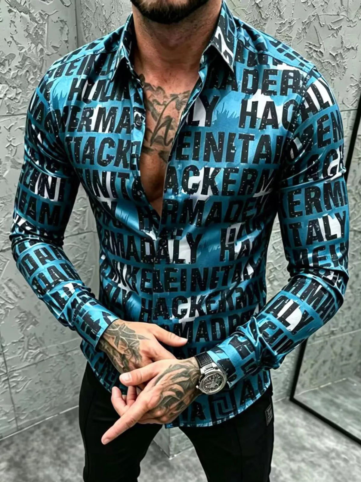 Model wearing teal letter-print shirt with hands clasped