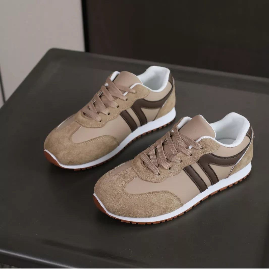 Pair of beige round-toe lace-up sneakers with dark side stripes