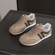 Pair of beige round-toe lace-up sneakers with dark side stripes