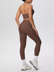 Angled rear view of brown leggings and halter top