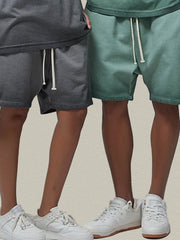 Models wearing gray and green drawstring shorts