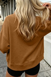 Back view of brown sweatshirt styled with shorts