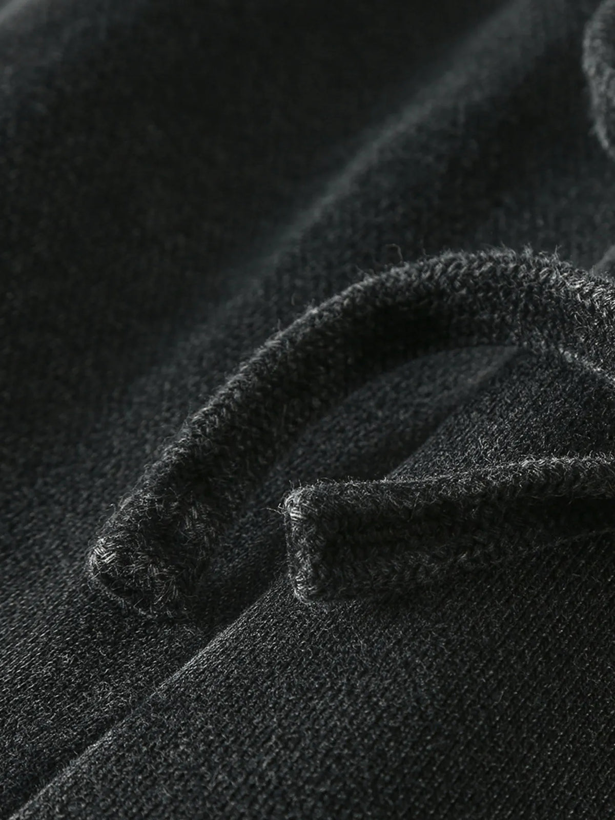 Close-up of the black fabric and hem stitching