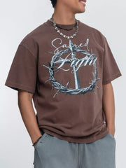 Model wearing brown washed tee with ornate circular graphic