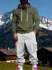 Front view of a model wearing an olive hoodie with chest flap pockets and grey cargo sweatpants