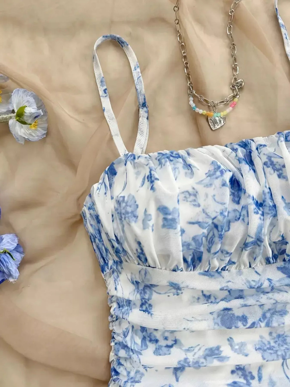 Detail of blue floral ruched dress neckline and bodice