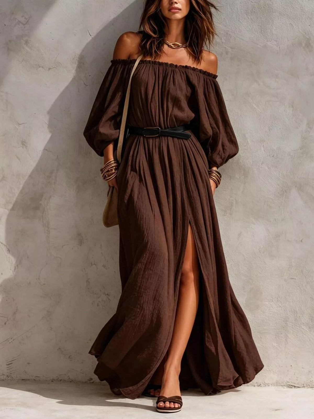 Model wearing dark brown off-shoulder maxi dress with long sleeves and belt