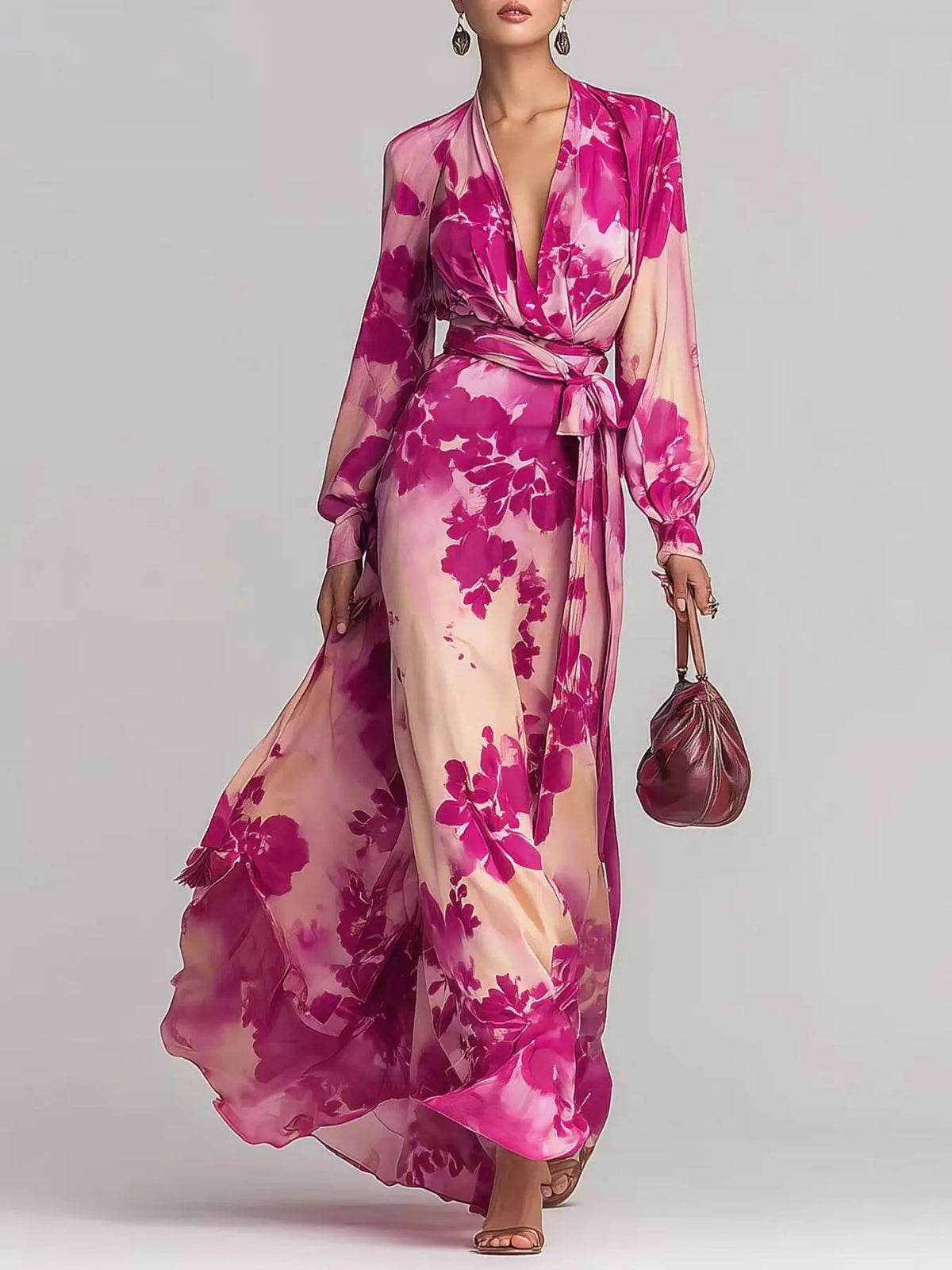 Pink floral maxi dress with long loose sleeves, a deep V-neckline and a tied waist, front view.
