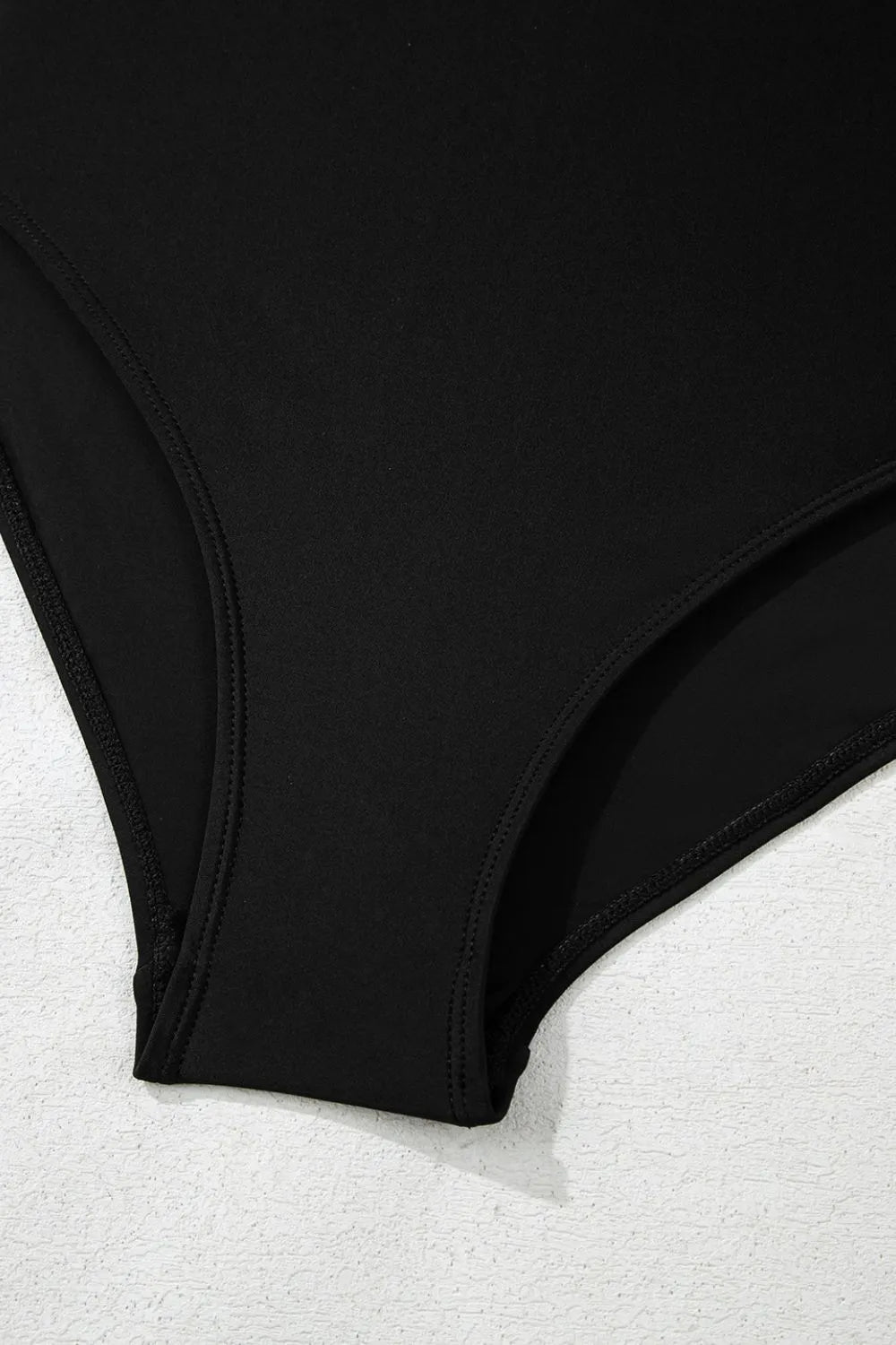 Close view of the black swimsuit brief lining beneath the skirt.