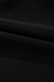 Detail of the black swim dress skirt fabric and seam.