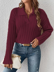 Woman wearing a deep burgundy ribbed polo-collar sweater with jeans